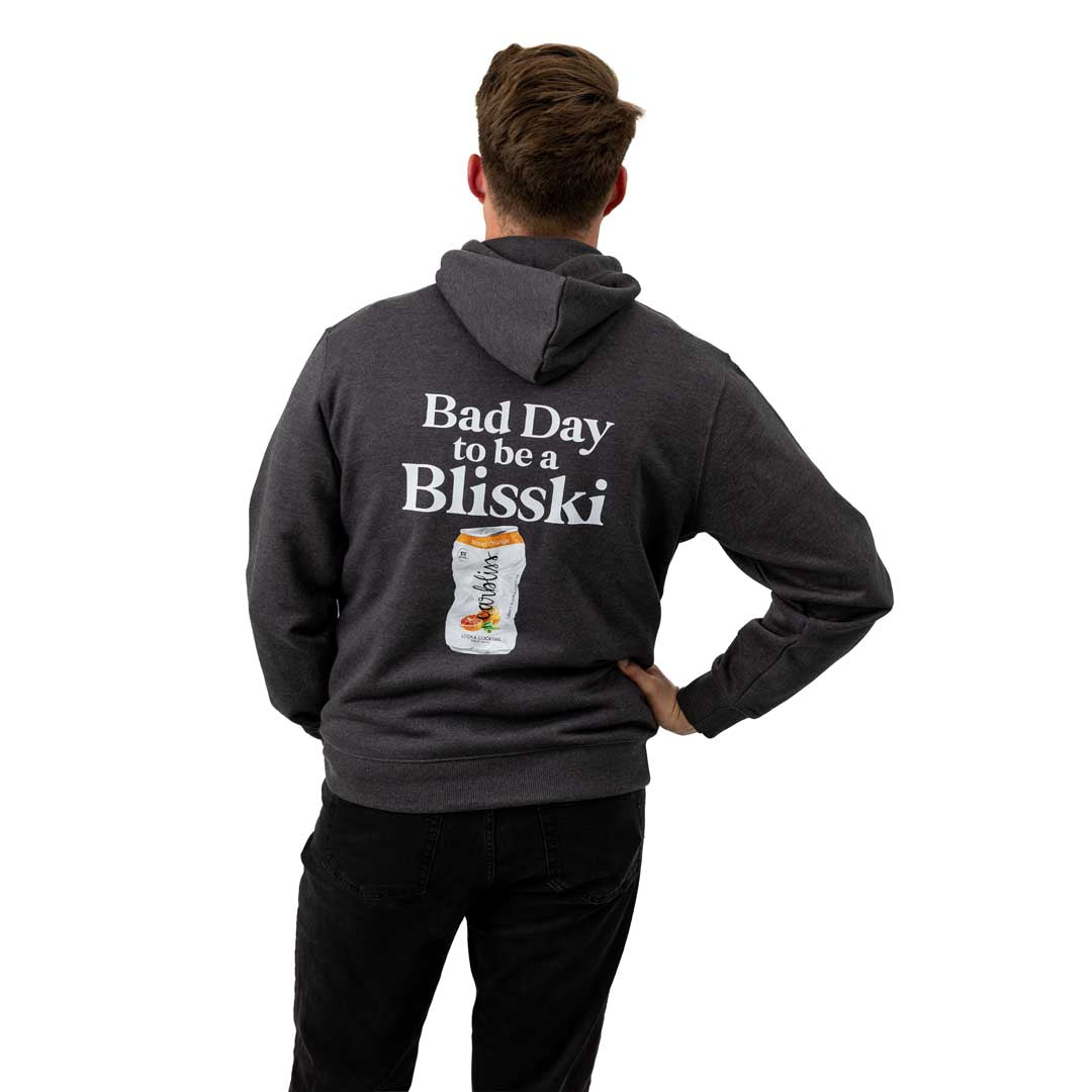 Person wearing a dark gray hoodie with 'Bad Day to be a Blisski' text and graphic on the back.