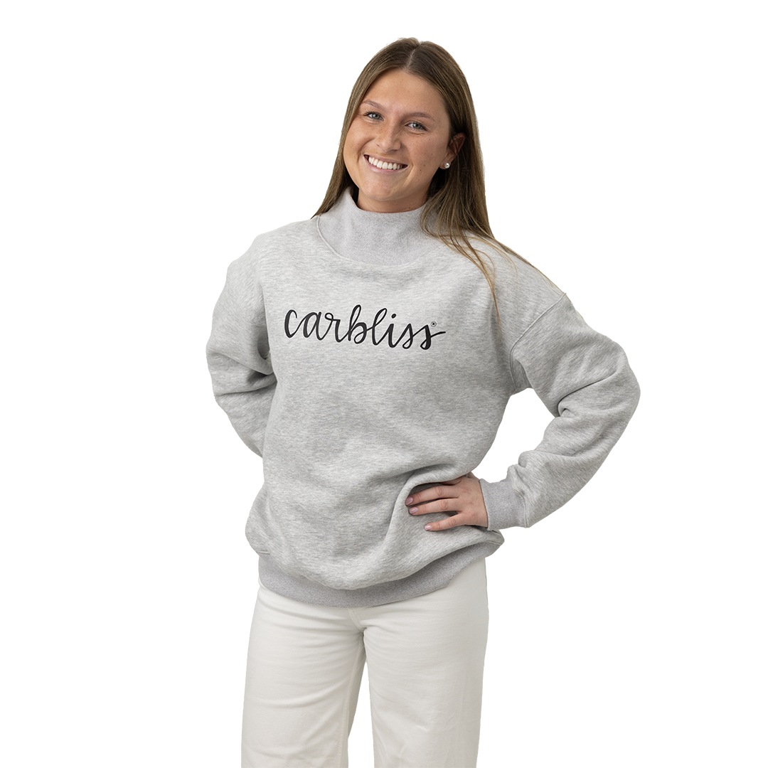 Woman wearing a gray sweatshirt with 'carbliss' text on a white background