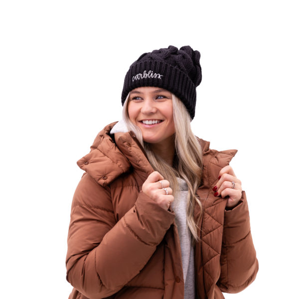 Natalie wearing Carbliss beanie with a pom looking to the right